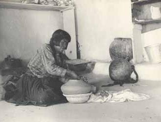 Woman identified as Nambaya, molding clay pot Platinotype photograph